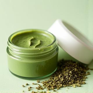 Container of green tea face mask.